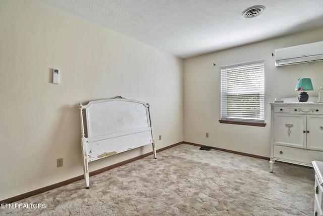 27 Brambleton Ct, Crossville, TN 38558 - unfurnished bedroom with a wall unit AC, light carpet, and a textured ceiling