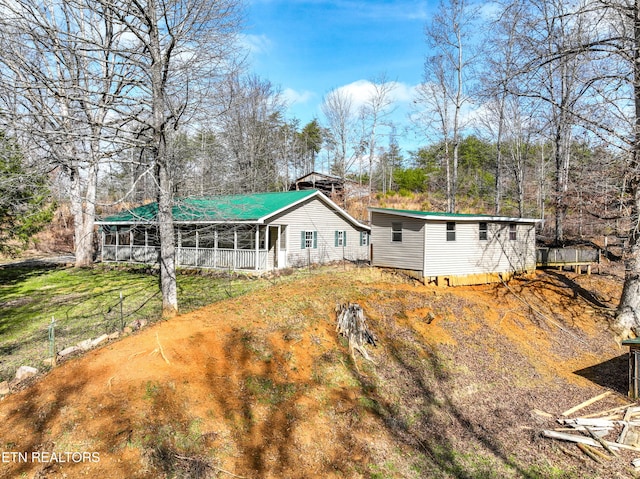 back of property with a sunroom