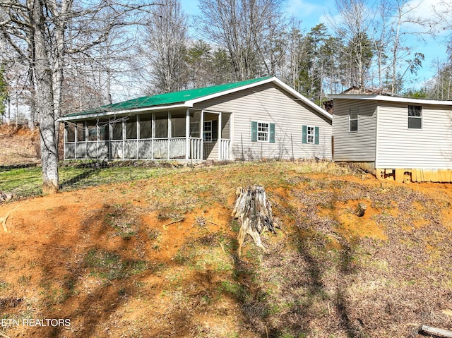 back of house with a sunroom