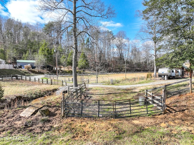 view of yard with a rural view and fence