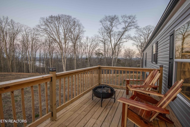 wooden deck with an outdoor fire pit