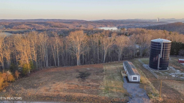 aerial view at dusk featuring a mountain view