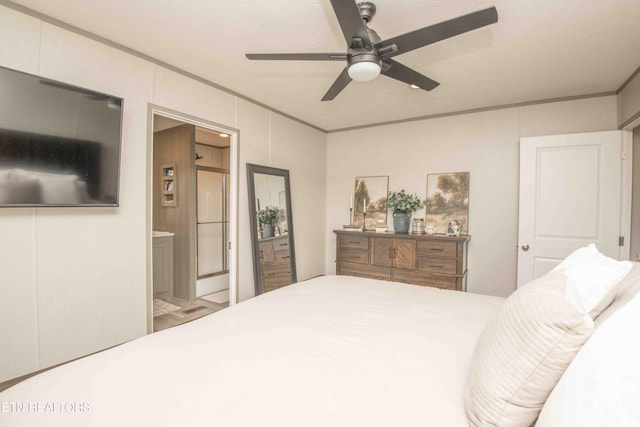 bedroom with a ceiling fan, ensuite bathroom, and ornamental molding