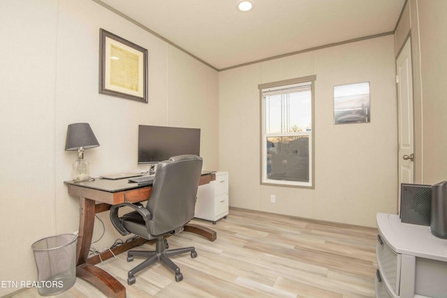 office area with ornamental molding and light wood finished floors