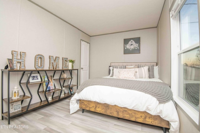 bedroom featuring crown molding and wood finished floors