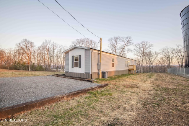 view of side of property featuring gravel driveway