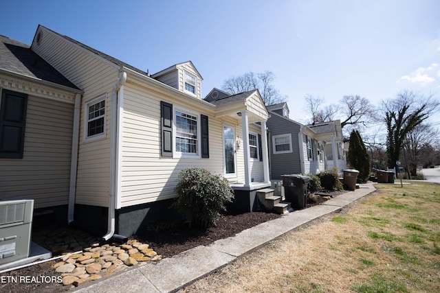 view of side of property with central AC