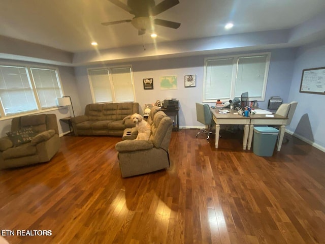 living room with ceiling fan and dark hardwood / wood-style flooring