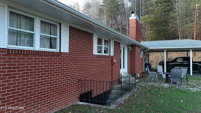 view of side of property featuring a carport