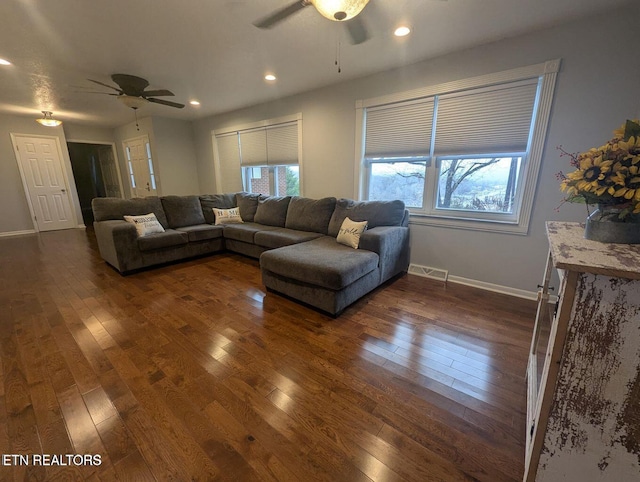 living room with ceiling fan and dark hardwood / wood-style floors