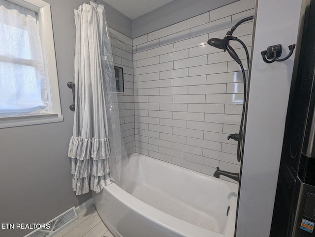 bathroom featuring shower / bath combination with curtain