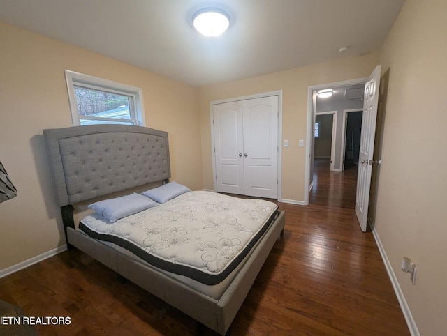 bedroom with dark wood-type flooring and a closet