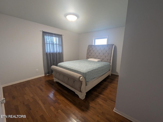 bedroom with dark wood-type flooring