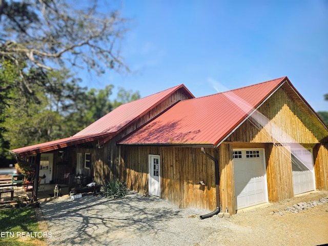 view of front of property featuring a garage and an outdoor structure