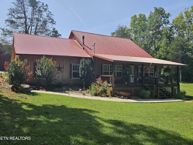 rear view of property with a lawn and covered porch