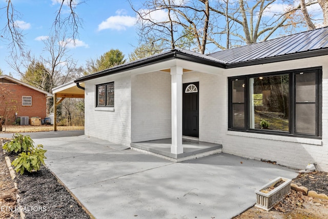 exterior space with central air condition unit and a patio area