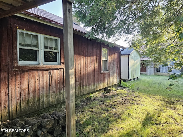 view of property exterior featuring a storage shed and a lawn