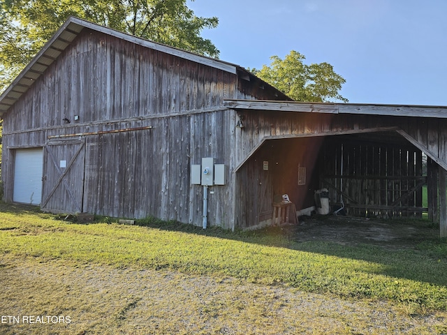 view of outbuilding featuring a lawn