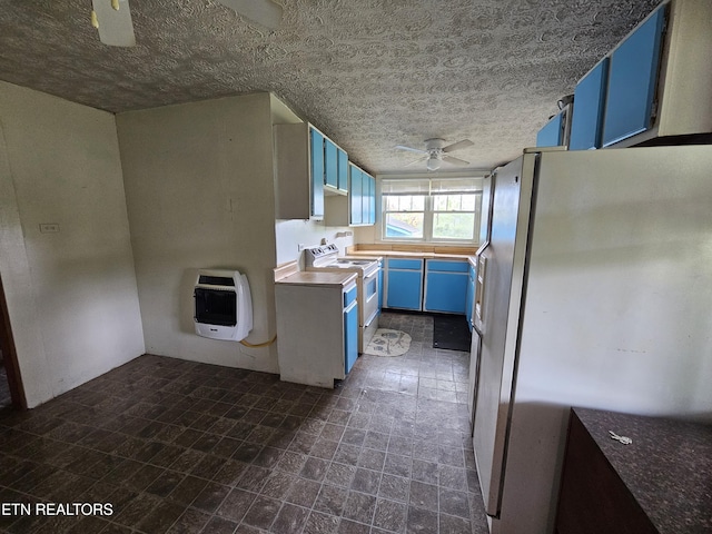 kitchen with blue cabinets, ceiling fan, heating unit, and white appliances