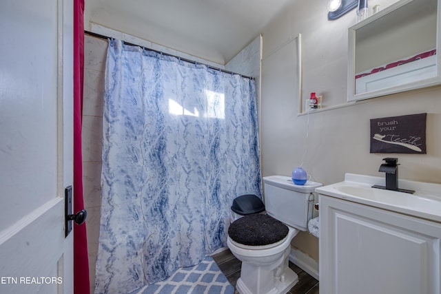 bathroom with walk in shower, vanity, and toilet