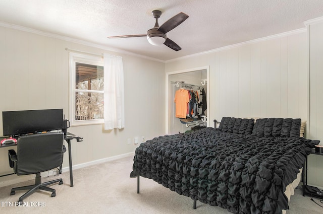 bedroom featuring crown molding, light colored carpet, and a textured ceiling