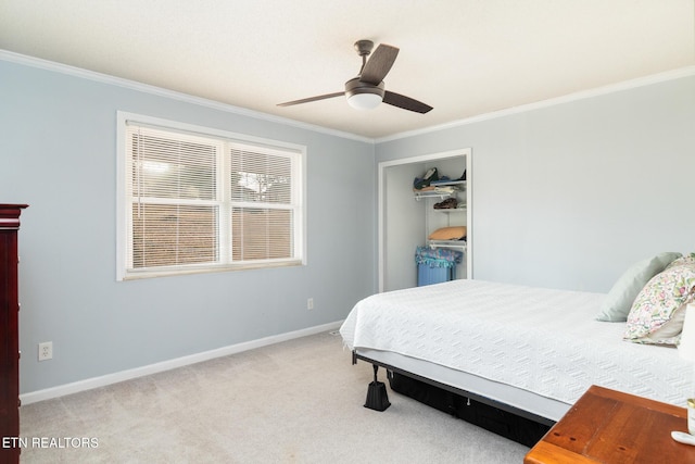 carpeted bedroom featuring crown molding, ceiling fan, and a closet