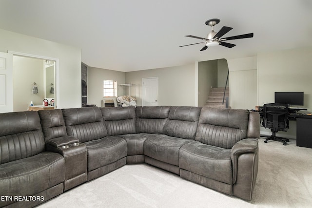 carpeted living room with ceiling fan