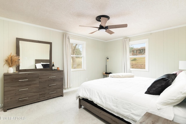 bedroom featuring multiple windows, ornamental molding, and a textured ceiling