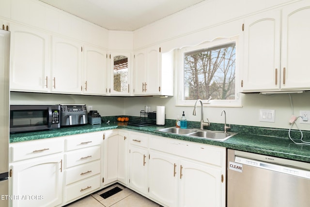 kitchen with appliances with stainless steel finishes, sink, and white cabinets