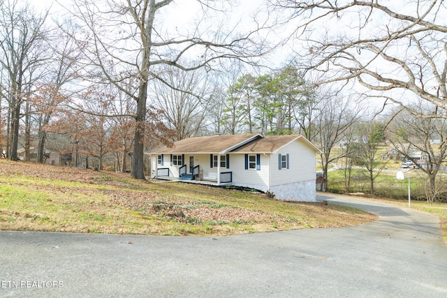 view of front of house with a front yard and covered porch