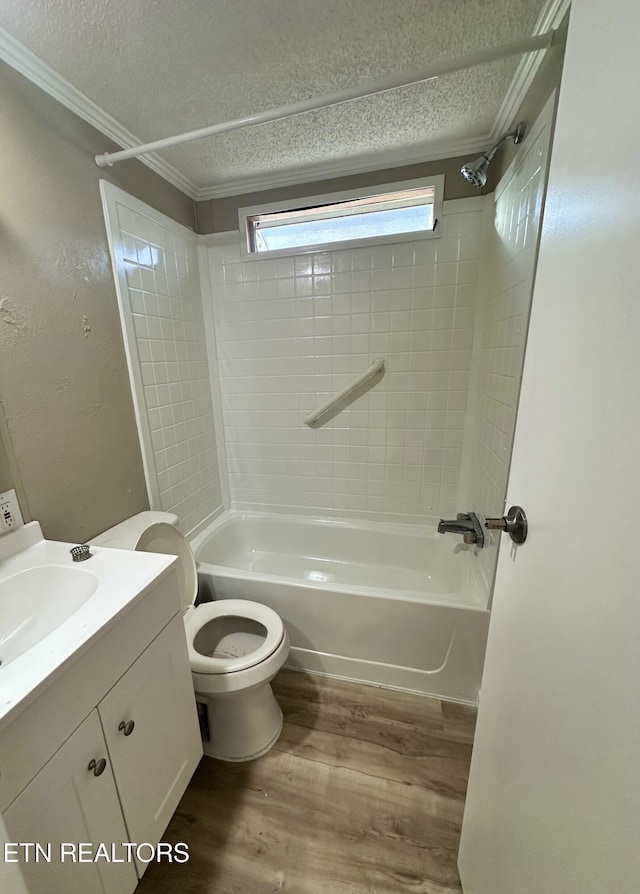 full bathroom with toilet, tiled shower / bath, wood-type flooring, a textured ceiling, and vanity