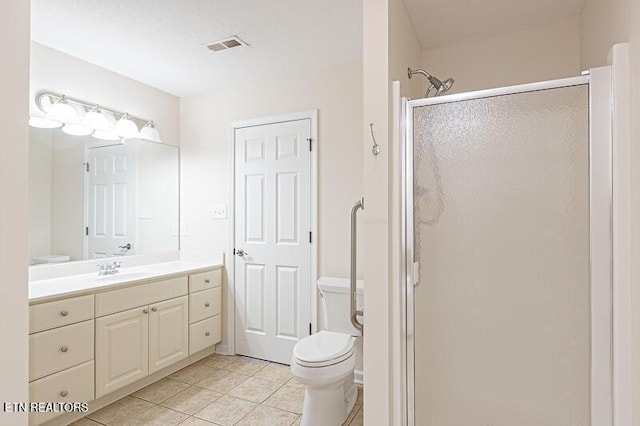 bathroom with tile patterned floors, vanity, toilet, and an enclosed shower