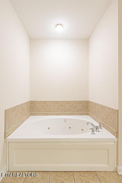 bathroom with tile patterned flooring and a tub