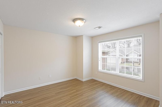 empty room featuring hardwood / wood-style flooring