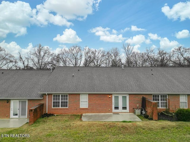 back of house featuring french doors, a lawn, central air condition unit, and a patio area