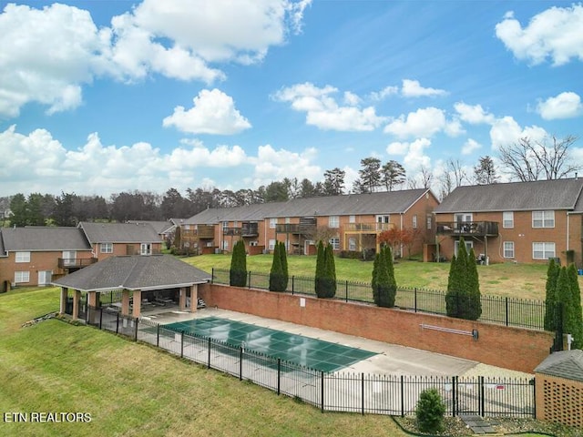 view of swimming pool featuring a lawn