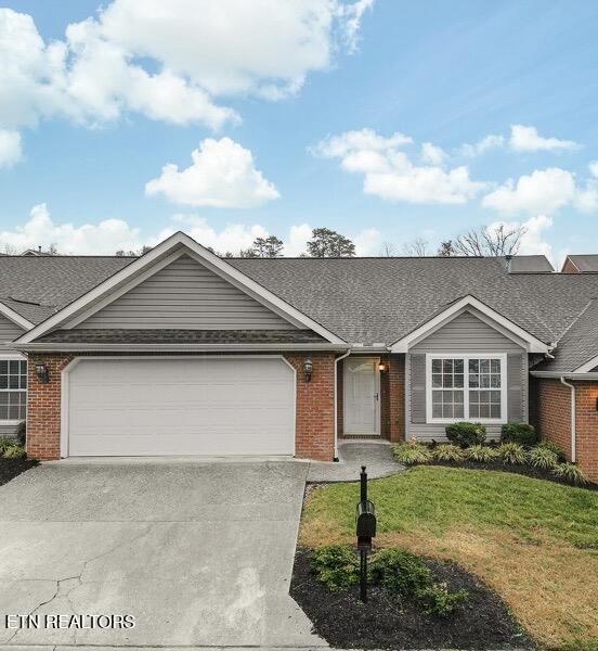 ranch-style home featuring a garage and a front yard