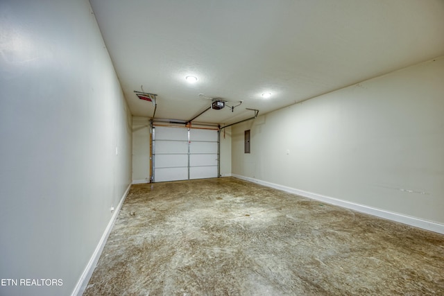 garage with baseboards, electric panel, and a garage door opener