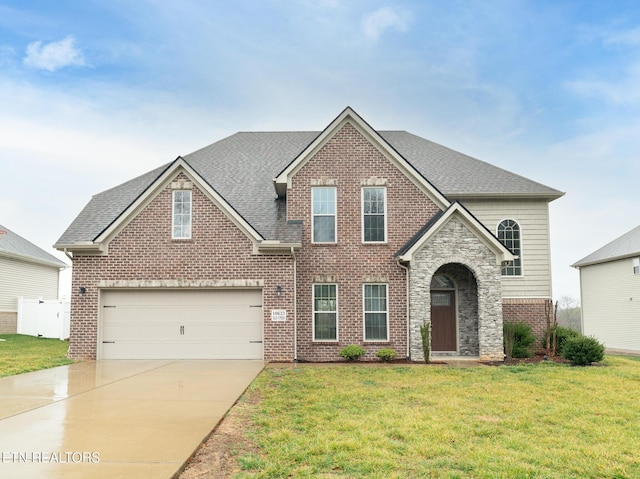 view of front of house featuring a garage and a front lawn