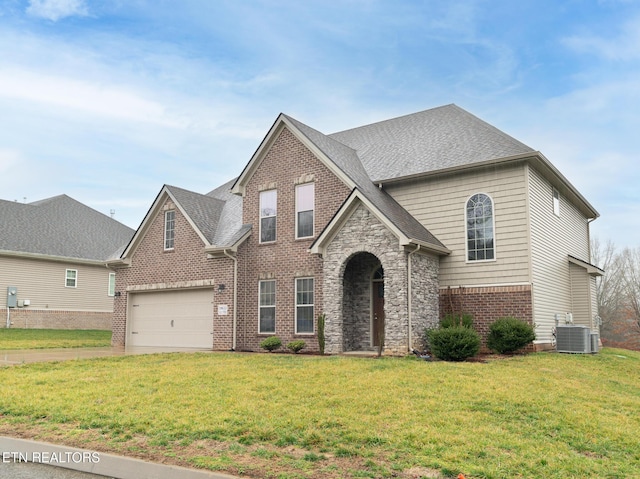 view of front of home featuring a garage, central AC unit, and a front lawn