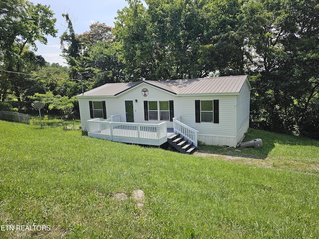 277 Coolidge Rd, Lafollette, TN 37766 - manufactured / mobile home with a deck, a front lawn, and a metal roof