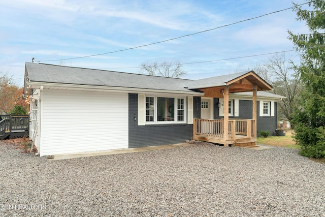 ranch-style house with a wooden deck and covered porch