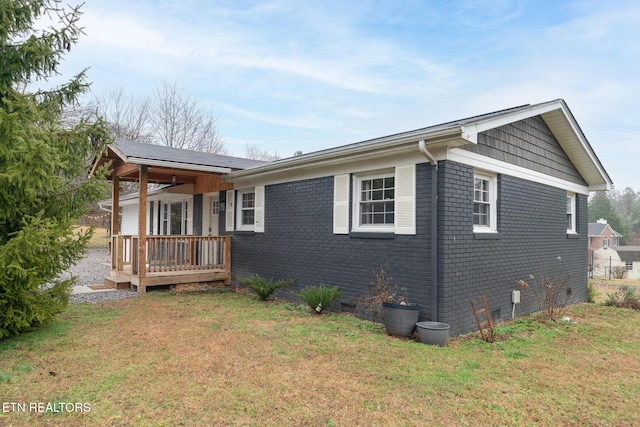 view of side of home featuring a yard