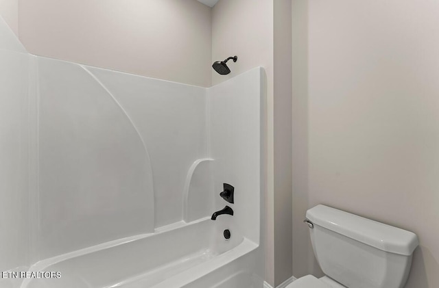 bathroom featuring toilet and tub / shower combination