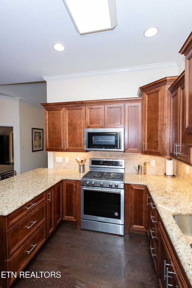 kitchen with backsplash, ornamental molding, light stone countertops, and appliances with stainless steel finishes