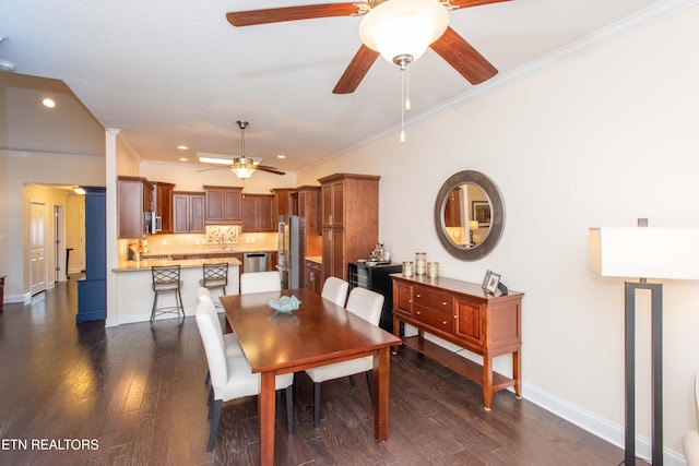 dining room with crown molding and dark hardwood / wood-style floors