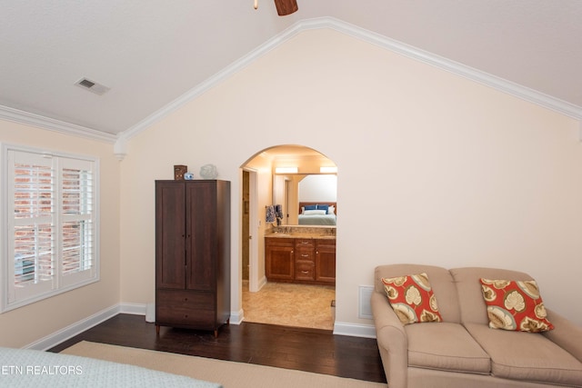 bedroom with dark wood-type flooring, crown molding, and high vaulted ceiling