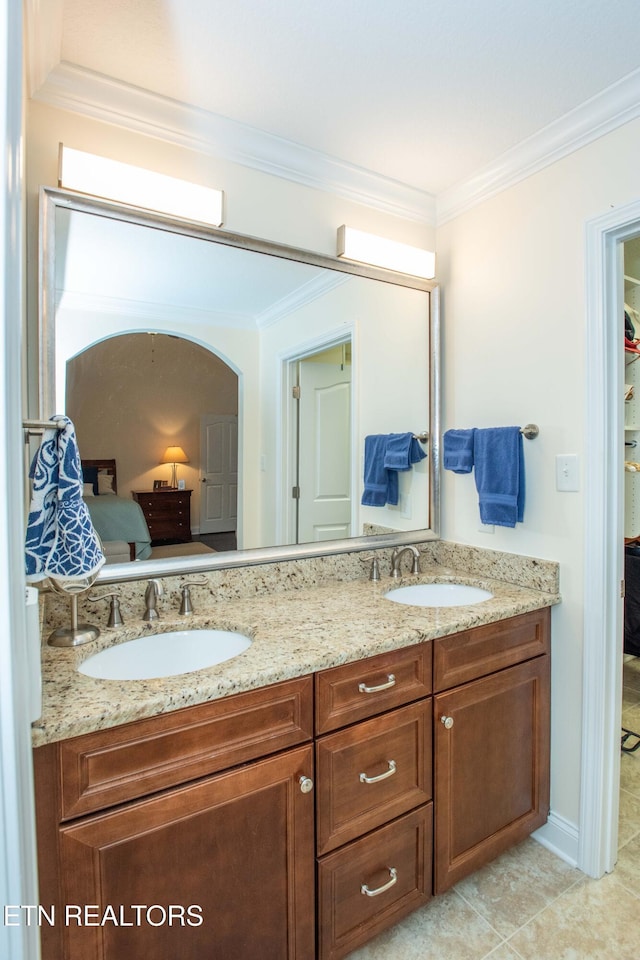 bathroom featuring crown molding, vanity, and tile patterned floors