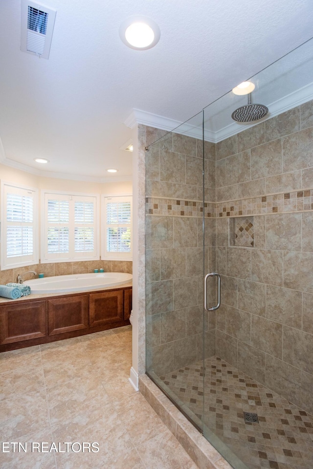 bathroom featuring tile patterned flooring, ornamental molding, and shower with separate bathtub