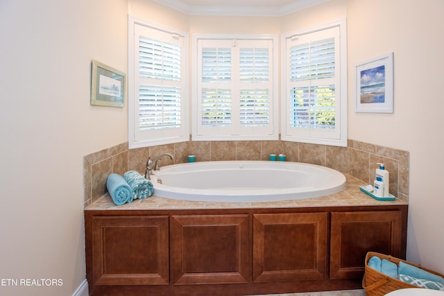 bathroom with a wealth of natural light and tiled tub